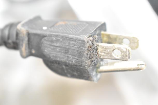 Close-up image of a damaged plug for a Waring WIH400 induction range, showing frayed and exposed wires.