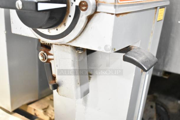 Mahlkonig K32S10 commercial coffee grinder, 115 Volts, visible rust, wear on metal, adjustment knob, lever for operation.