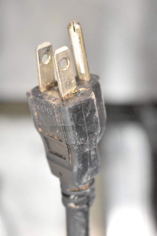 Mahlkonig K32S10 coffee grinder plug, 115 volts, used condition, visible wear on prongs and casing.