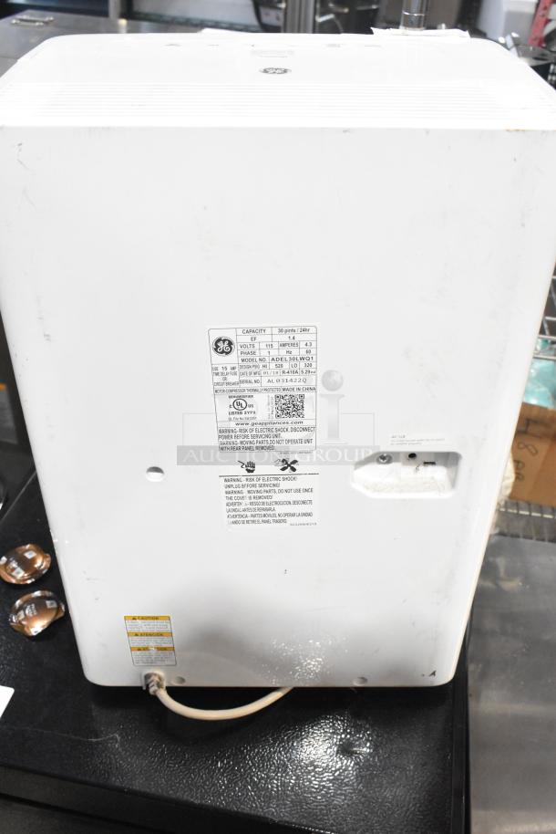 2018 GE ADEL30LWQ1 dehumidifier, 115 volts, 1 phase, with visible label detailing specifications. Good condition.