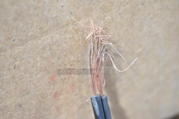 Frayed copper wiring with plastic insulation, close-up.