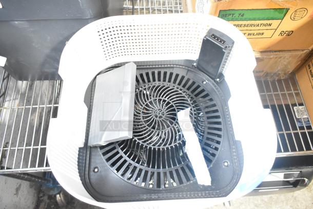Two various fans, including a Midea model, in good condition. Features include black grill design and white casing.