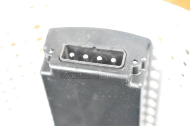 Two electric fans, including a Midea model, partially visible. Features sleek design, possibly in good condition. No visible tags.