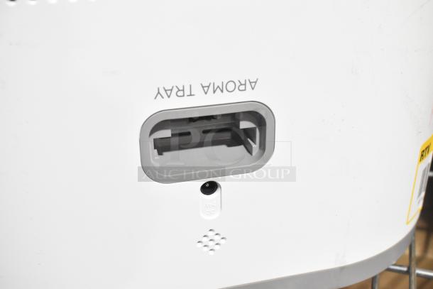 Two fans including a Midea model, featuring an aroma tray and power input. Condition appears slightly used. Auction includes both units.