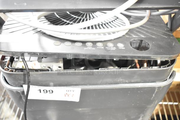 Two various fans, including Midea, with visible controls and a label marked "199 QTY VX2" indicating quantity and bidding info.