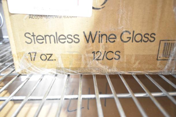 Box of Acopa 5535517 17 oz. stemless wine glasses, labeled for customization, new with scratches and dents, 12 per case.