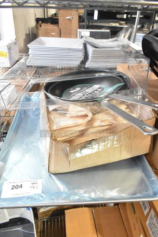 Brand new items including 10" and 12" Choice non-stick fry pans, Intedge ivory cloth napkins, and 19GA bun pans, in packaging.