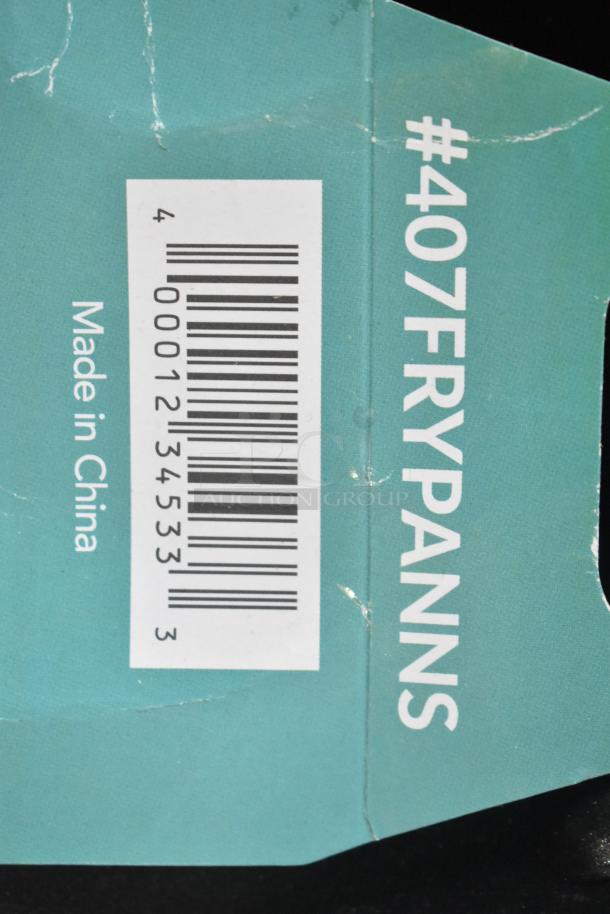 Auction item tag for fry pans, barcode visible. Tag reads #407FRYPANNS, "Made in China," slightly worn condition.