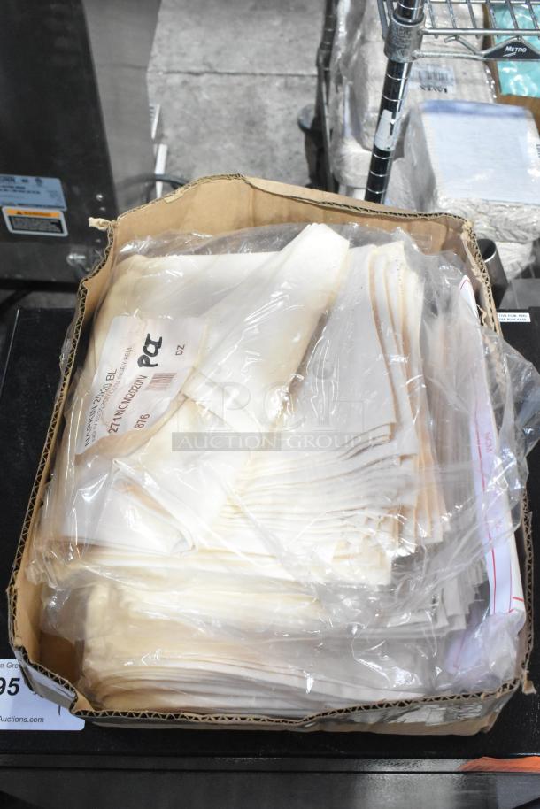 Box of Intedge Ivory 65/35 polycotton blend napkins, 20"x20", in plastic wrap. New condition with visible label showing "12DZ".