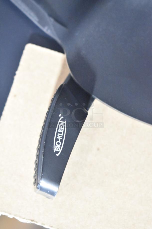 Brand new Bio-Kleen Poly Wall Mount Paper Towel Dispenser, black with minor scratches, features logo on the handle.