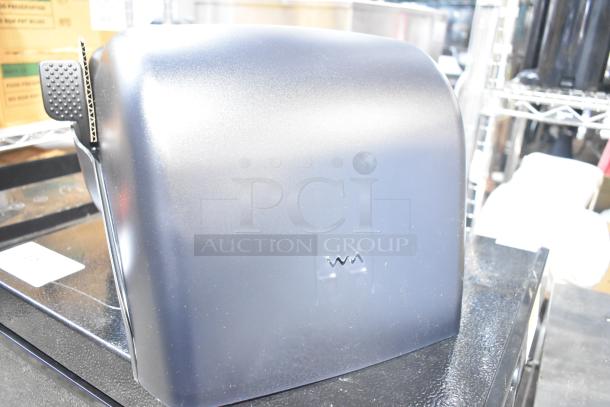 BRAND NEW Bio-Kleen Poly Wall Mount Paper Towel Dispenser with minor scratches, shiny black finish, model-specific markings visible.