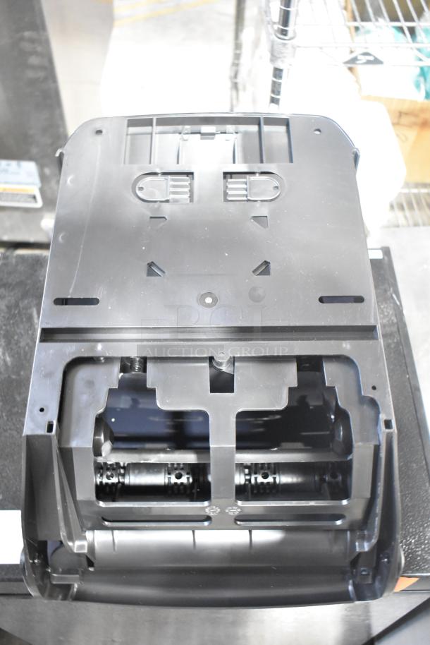 Brand new Bio-Kleen Poly wall mount paper towel dispenser, scratch and dent, black plastic, open front view.