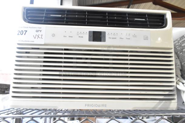 Frigidaire window mount air conditioning unit, front view, with control panel and air vents, on metal shelf.