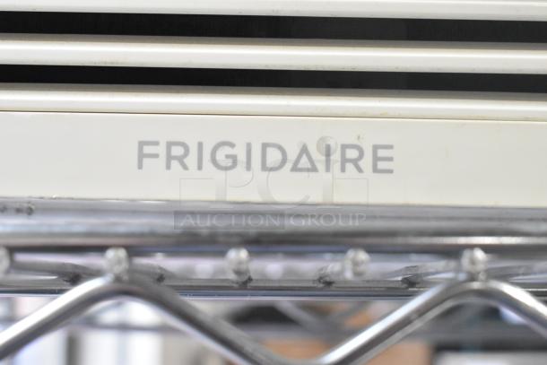 2 window mount air conditioners: LG and Frigidaire. Visible Frigidaire label. Used condition, metallic finish.