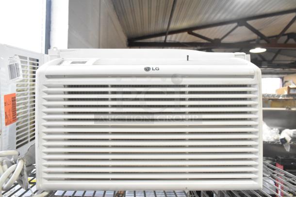 Two window mount air conditioning units, LG and Frigidaire, in good condition, visible control panel, with labels indicating model details.