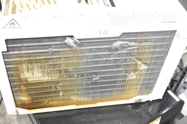 Two window mount air conditioning units, LG and Frigidaire, showing usage wear. Auction offers double the bid.