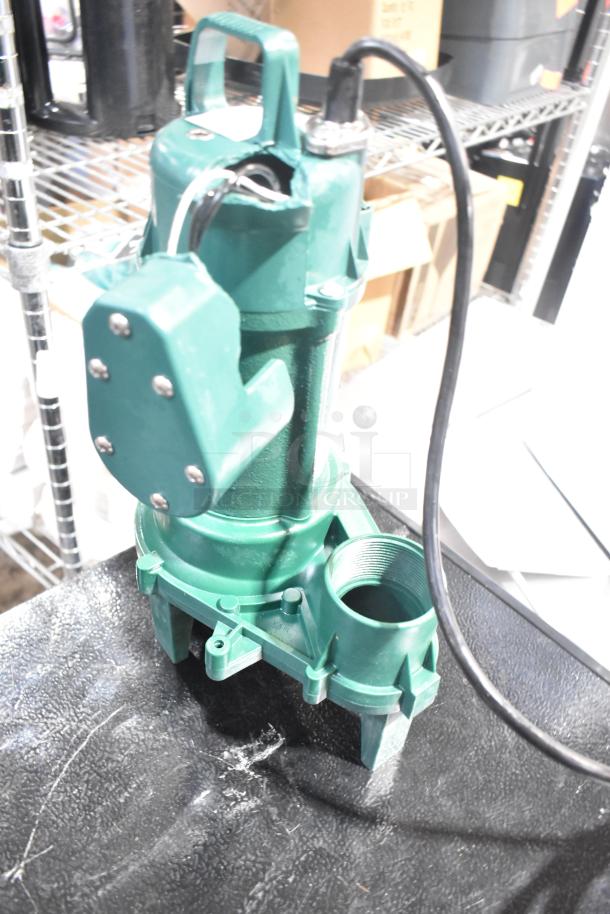 Brand new Zoeller 212-0001 M212 sewage pump, 115V, green, with minor scratches and dents, visible wiring and handle.