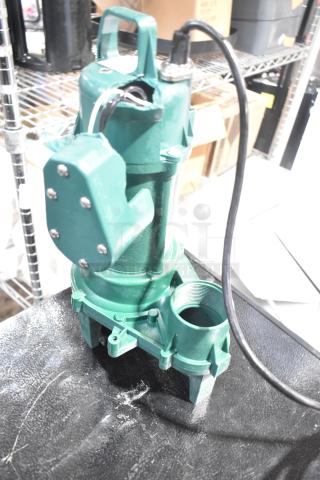 Brand new Zoeller 212-0001 M212 sewage pump, 115V, green, with minor scratches and dents, visible wiring and handle.