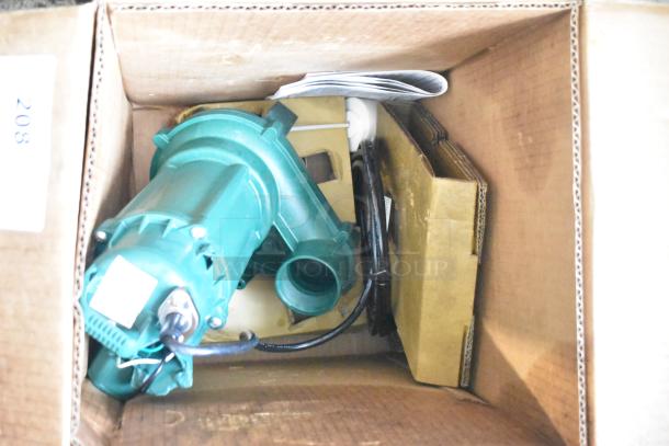 Brand new Zoeller 212-0001 M212 Sewage Pump, 115V, in original box with minor scratches, includes manual and packaging.
