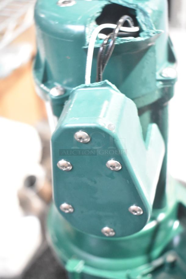 Brand new Zoeller 212-0001 M212 Sewage Pump, 115V. Scratch and dent condition, green exterior with wiring visible.