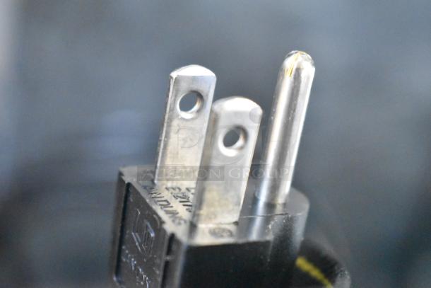 Close-up view of a power plug for a Zoeller 212-0001 M212 Sewage Pump, 115V, brand new but with minor scratches.