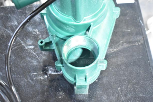 Brand new Zoeller 212-0001 M212 Sewage Pump, 115V, green, showing slight scratches. Durable construction.