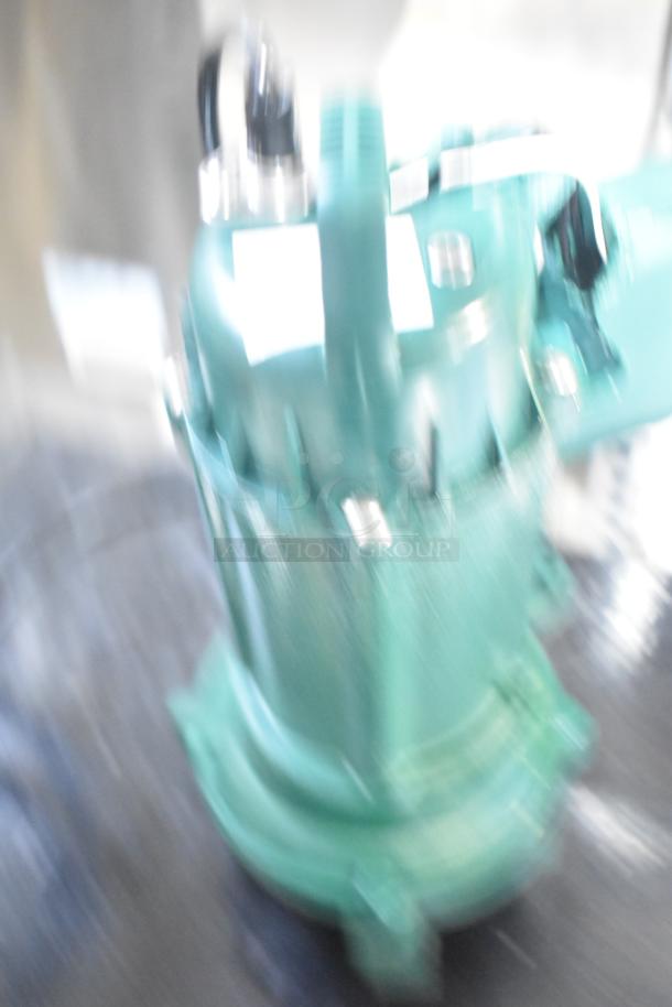 Blurry image of Zoeller 212-0001 M212 sewage pump, brand new with minor scratches. Model label barely visible.