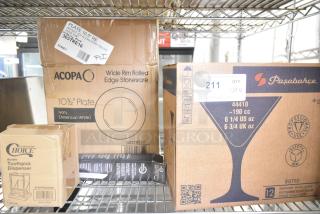 4 brand new items on a shelf: Pasabahce Bistro glasses, Choice acrylic toothpick dispenser, Mercer Culinary serrated knife, and Acopa stoneware plates.