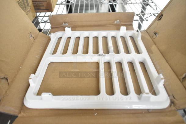 BRAND NEW Zurn Elkay JP2376-T cast iron enameled grate for FD2376 floor sinks shown in original packaging, minor scratches visible.