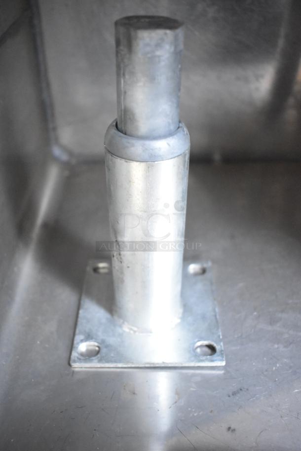 Set-n-serv Drop Ice Bin with a sturdy stainless steel construction, featuring a mounted post. Appears in good condition.