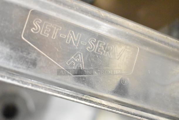 Set-n-serve Drop Ice Bin with embossed logo, metal construction, visible markings, in good condition.