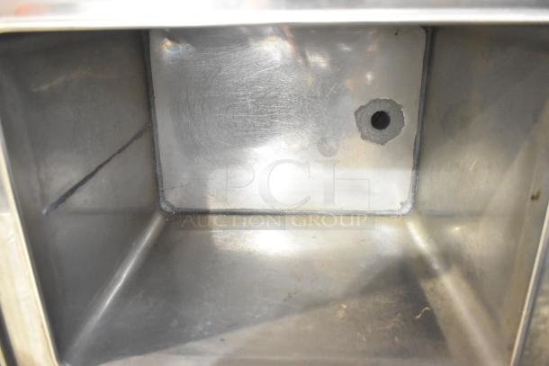Stainless steel Set-n-serv Drop Ice Bin, showing interior with small drainage hole, in good condition.