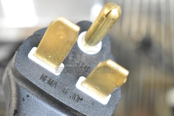 Close-up of a power plug with NEMA 6-30P marking, part of the Vollrath JT2000 Conveyor Toaster.