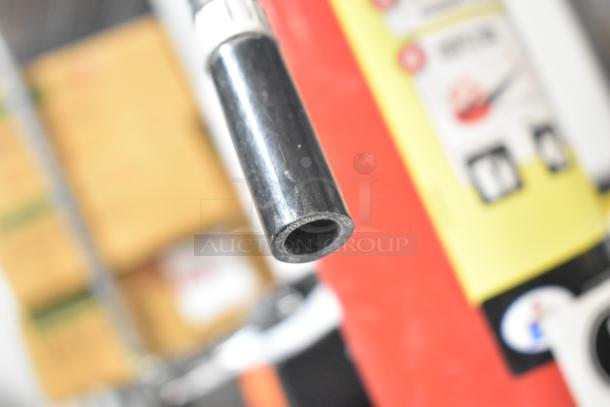 Fire extinguisher with visible nozzle, bright label, pick up only. Condition and brand details not visible.