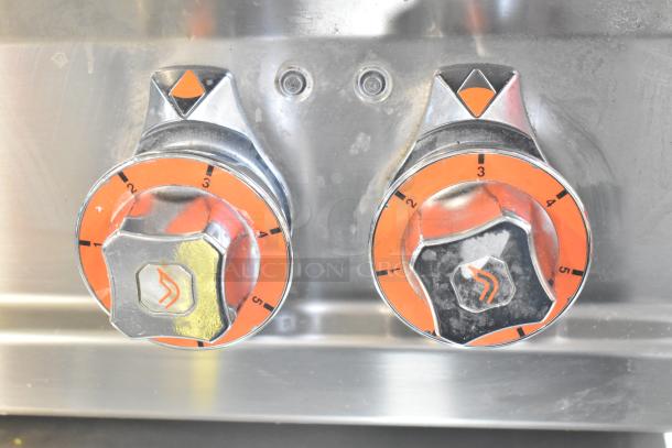 2023 Lotus PCT-66ET electric countertop range knobs, showing burner controls with orange markings.