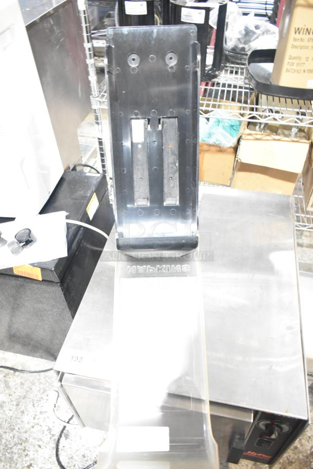 Black and clear poly countertop napkin dispenser in good condition with visible "Napkins" label on the front.