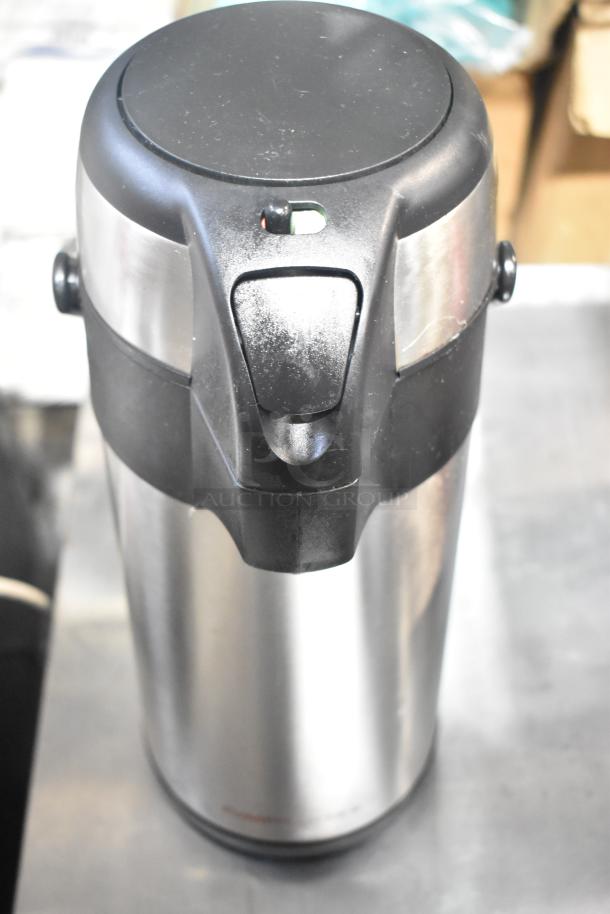 Hamilton Beach beverage dispenser in stainless steel, black top, good condition, suitable for drinks, catering, or events.