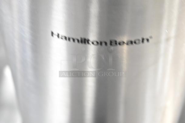 Hamilton Beach stainless steel beverage dispenser, visible brand logo, part of auction bundle including Oggi Air Pot and 2023 Bunn SH SERVER.