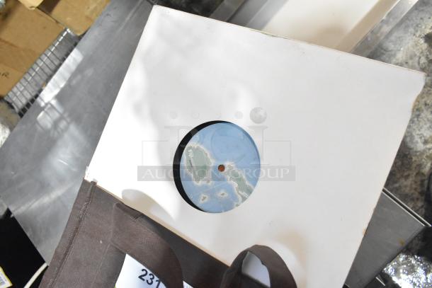 Lot including records with visible label showing a map design, housed in a white sleeve, part of a mixed-items auction.