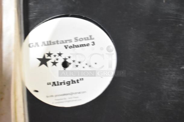 Vinyl record labeled "GA Allstars Soul Volume 3" with track "Alright" showing moderate wear. Includes contact information on label.