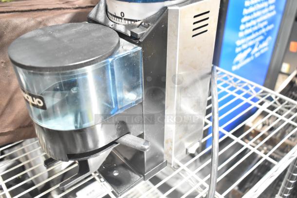 Rancilio Rocky Doser espresso bean grinder, 115 volts, countertop model. Slight wear on the exterior, blue tint hopper.