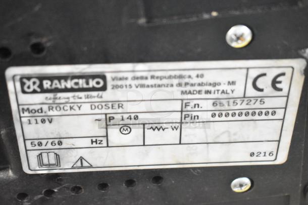Rancilio Rocky Doser espresso grinder label showing model details: 110V, 50/60Hz, made in Italy.