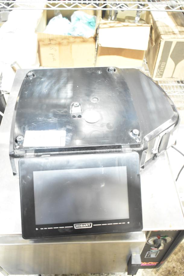 2024 Hobart HTi-7LH4W commercial countertop scale, black, touchscreen, 120/208-240 volts, 1 phase, marked with Hobart logo.