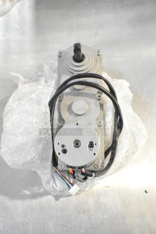 Royal Kincool FL57BLS01-24V-4000AD-01 round motor, silver, wires attached, in new condition with bubble wrap packaging.