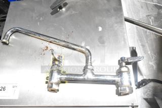 Stainless steel faucet with handles, moderate wear, for auction. Features QR code label, item number tag visible.