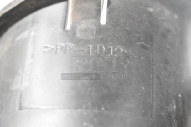 Close-up of an item showing the marking "PP-TD12" on a dark surface. Exact item unidentified.
