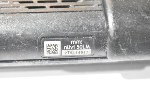 Garmin nüvi 50LM GPS unit with model number 2T9144947. Black casing, lightly dusted, vented back design.