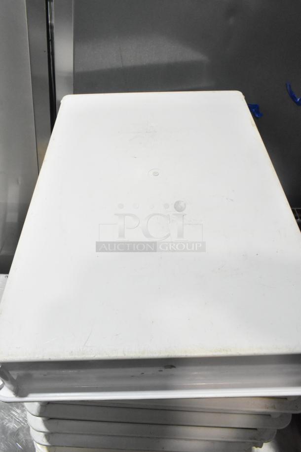 Nine white poly dough bins, slightly worn, stackable, ideal for commercial kitchens; 9 times your bid is reflected in the lot.