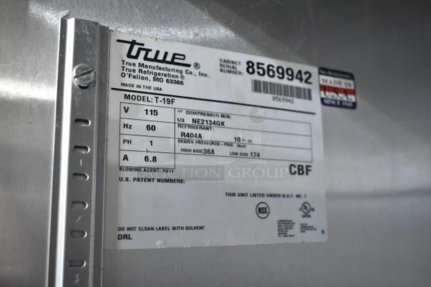 True T-19F Commercial Freezer, 115V, single door, on casters. Visible label shows model, voltage, and refrigerant details.
