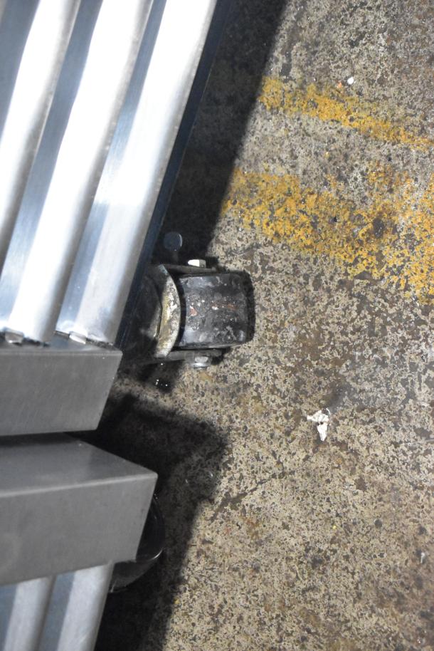 True T-19F commercial freezer on casters, 115V, 1 phase, showing caster detail and bottom edge of freezer.